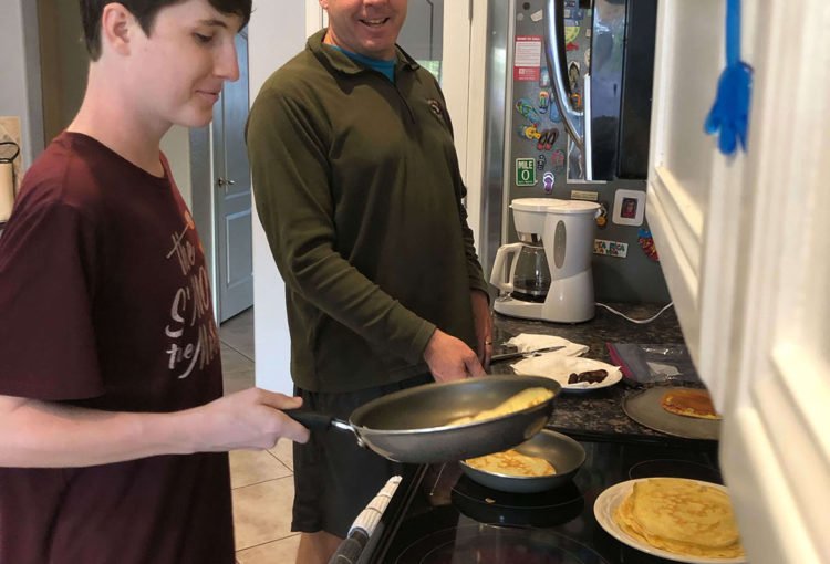 Jaxon and his Dad flipping pancakes